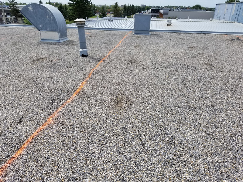 Gravel roof of a commercial building Before removal